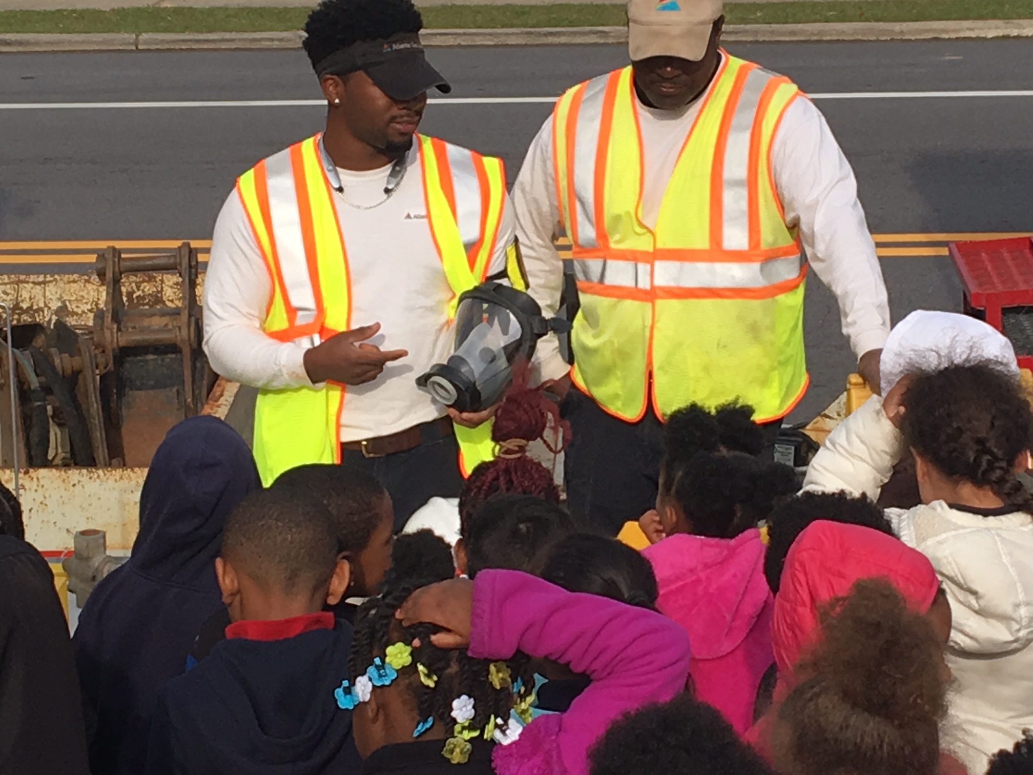 Two Southern Company employees stand in front of school children