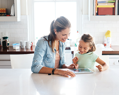 Woman with child looking at tablet