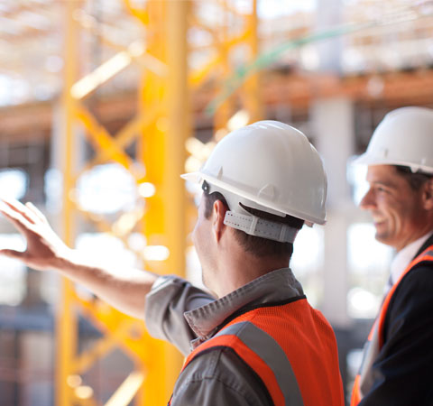 Construction workers looking out over construction site