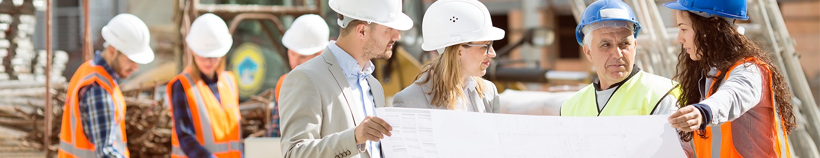 Four builders looking at a paper plan