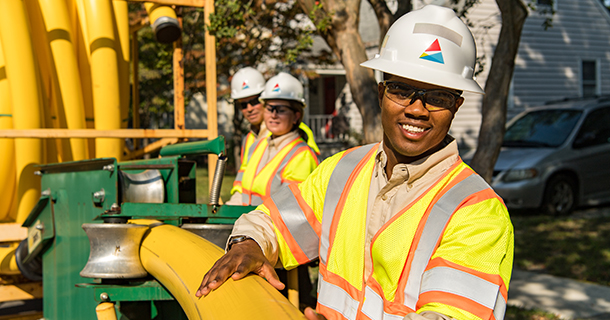 Southern Company employees smiling in front of pipelines
