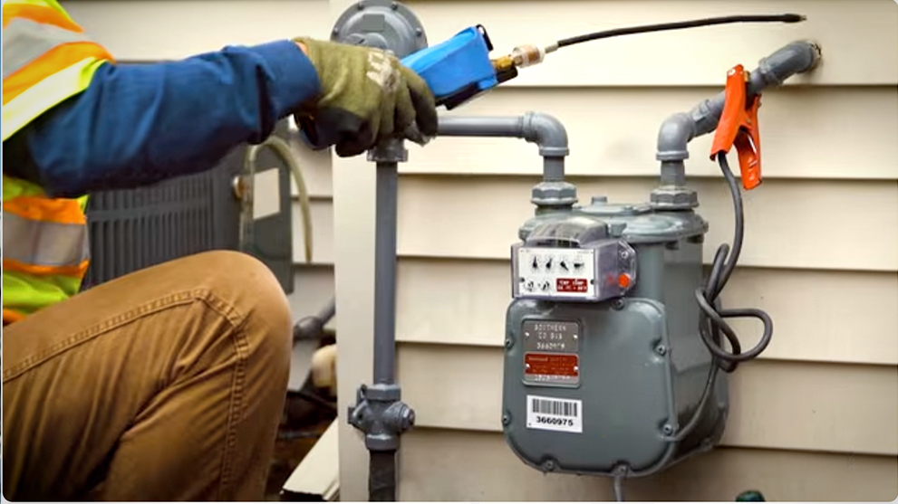 worker testing a gas meter