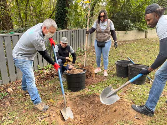 Atlanta Gas Light Senior Environmental Specialist Allen Jacks, Environmental Programs Manager Patrick Winnubst, Senior Environmental Specialist Dorian Afanador and Senior Category Manager Demetrious Ward ensure the hole is three times wider than the root mass and not deeper than the tree's previous environment.