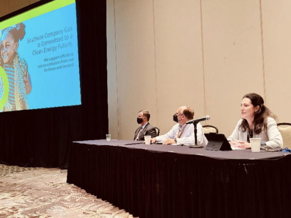 Joanne Mello speaks as part of a panel of energy experts in conference room