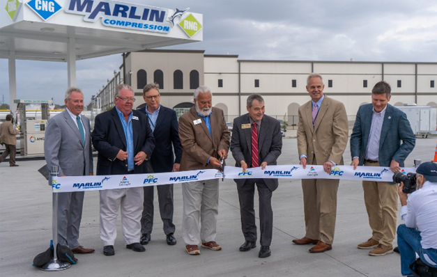 group of men cutting a ribbon